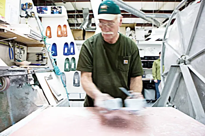 Man crafting custom orthotics at Northwest Podiatric Laboratory.